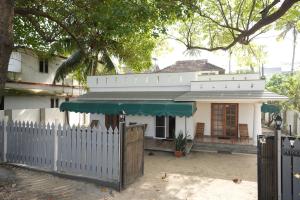 a white house with a fence in front of it at Peyolis Place in Jāmb