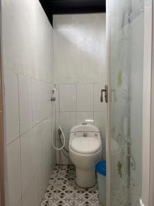a small bathroom with a toilet and a shower at Lego Lego Bulubarakka homestay and cafe in Kasijala +27 photos