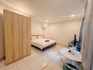 a bedroom with a bed and a sliding door at The Cony in Pattaya South