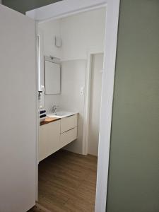 ブールジュにあるMaison Aéroport Bourgesの洗面台と鏡のある白いバスルーム