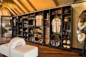 a room with a large wall of shelves with clothes at Chobe River Camp in Ngoma +15 photos