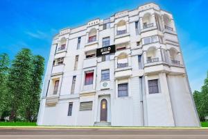 a white building with a sign on it at Hotel O Purasaiwalkam in Chennai +41 photos