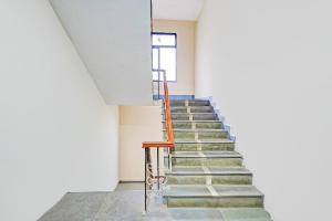a set of stairs in a building with a window at Hotel O Purasaiwalkam in Chennai