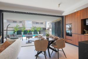 a dining room and living room with a table and chairs at Luxe villa Santa Rosalia in Torre-Pacheco