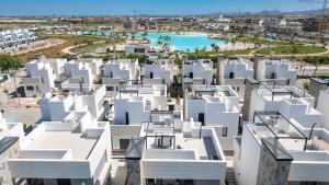 an aerial view of white buildings and a pool at Luxe villa Santa Rosalia in Torre-Pacheco