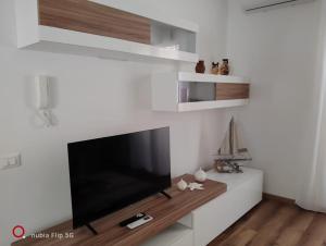 a living room with a large flat screen tv on a wall at Casa Sonia Apartment Mondello in Mondello