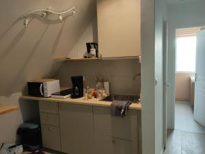 a kitchen with a sink and a microwave at Chez YEP, 4 chambres 9 couchages in Anzin-Saint-Aubin