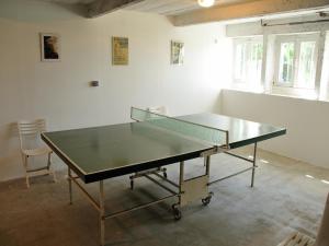 a ping pong table in the middle of a room at Seaside Comfort in Erquy in Erquy +32 photos