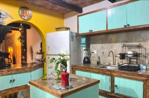 a kitchen with blue cabinets and a white refrigerator at Espacios Livemarlu casa de huéspedes in Coatepec