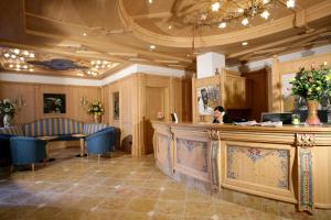 a woman sitting at a counter in a salon at Hotel Garni La Roccia in Andalo