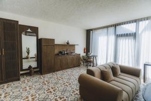 a living room with a couch and a mirror at Sunny Samudra Boutique hotel Uluwatu in Uluwatu