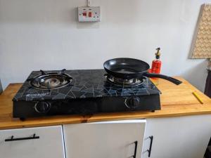 a stove top with a pan on top of it at Bella Residency in Mwanza