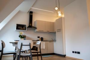 a kitchen and dining room with a table and chairs at Talvera Dream - City center, Rooftop, Garage & Jacuzzi in Bolzano