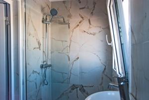 a bathroom with a shower and a sink at Skyline Loft in Mytilene