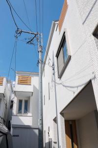 a white building with a pole next to it at SunRise STAY Haruna in Tokyo
