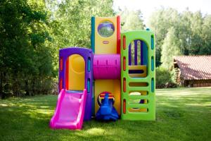 a group of childrens play equipment on the grass at Siedlisko Grabinowo k/Olsztyna in Olsztyn