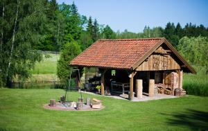 a large wooden pavilion in the middle of a field at Siedlisko Grabinowo k/Olsztyna in Olsztyn