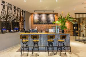 a bar in a restaurant with stools at Athome Boutique Hotel in Bintulu