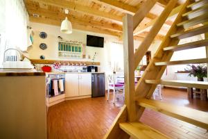 a kitchen with wooden floors and a wooden staircase at Siedlisko Grabinowo k/Olsztyna in Olsztyn