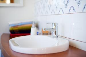a bathroom with a white sink and a wooden counter at Siedlisko Grabinowo k/Olsztyna in Olsztyn +31 photos