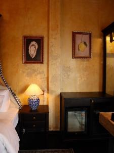 a bedroom with a bed and a lamp on a table at DEMO Inn & Ine - Poetic Studio Stay by ATV in Hanoi +58 photos