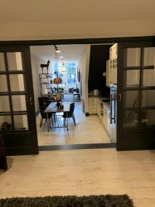 a kitchen and dining room with a table and a dining room at Unique Royal Basement residence in Amsterdam +19 photos