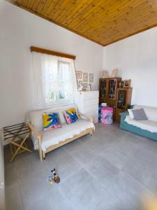 a living room with a couch and a window at "Villa Kanella"Sea View Hydra Kamini malouholidays in Hydra +22 photos