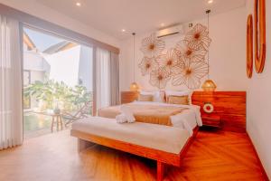 a bedroom with a bed and a large window at Charming 2BR Retreat with Private Pool & Garden View in Dalung +49 photos