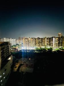 a view of a city at night with lights at Classic studio in Noida
