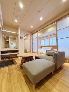 a living room with a bed and a table at Rakuyu asakusa in Tokyo
