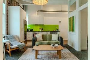 a living room with a couch and a table at Modern 2-Bedroom Central City Apartment in Wellington