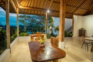 a dining room with a table and a view of the ocean at Kayun Retreat Mas Suite in Ubud