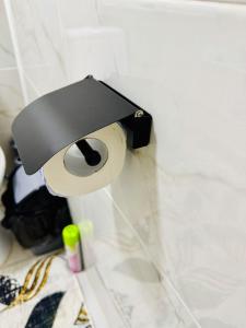 a roll of toilet paper hanging on a wall at Биржан Сал центр 2 к in Taldykorgan +2 photos