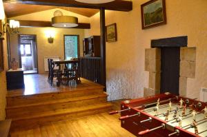 a living room with a pool table in the middle at Mas Sabaters - L'Era de Sabaters in Tavernoles