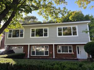 a house with white windows and a brick at 3 Bed 2 Bath Retro-Chic Comfort on the Crescent in St. John's