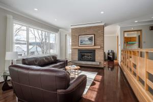 a living room with a couch and a fireplace at 3 Bed 2 Bath Retro-Chic Comfort on the Crescent in St. John's