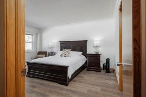 a bedroom with a bed and a chair at 3 Bed 2 Bath Retro-Chic Comfort on the Crescent in St. John's +31 photos