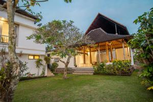 a house with a garden in front of it at Kayun Retreat Mas Suite in Ubud