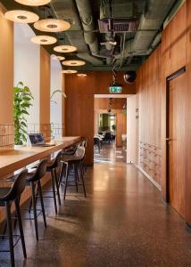a long table in an office with chairs and desks at Entre Hotel by Zdrojowa in Wrocław +44 photos