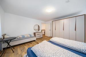 a bedroom with two beds and a table at City Villa Bad Dürrheim - Maisonette in Bad Dürrheim
