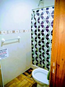 a bathroom with a toilet and a shower at Las Mozitas II in Chuy +10 photos