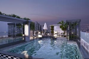 a swimming pool on top of a building at Manevi Premier Hotel in Hanoi
