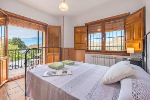 a bedroom with a bed and a balcony at Casa Hitos in Monachil +23 photos