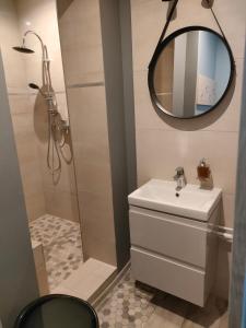 a bathroom with a sink and a mirror at Apartament nad jeziorem in Sława +12 photos