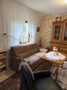 a living room with a couch and a table at Ferienwohnung Weber in Schleiden