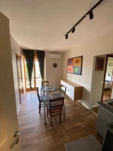 a living room with a glass table and chairs at Casa dell'Orso Biella in Biella