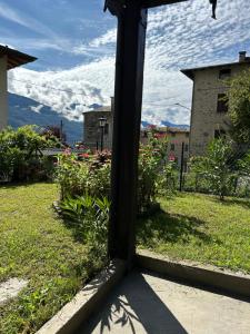 a view from a window of a yard with flowers at casa vacanza l'Oleandro in Poggiridenti +47 photos