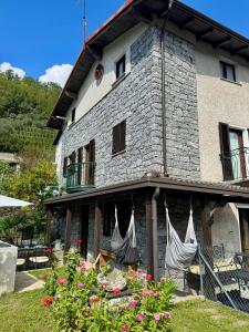 a building with hammocks on the side of it at casa vacanza l'Oleandro in Poggiridenti