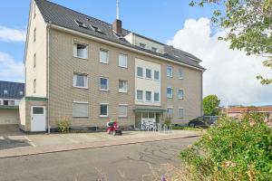 a large brick building with a red scooter in front of it at Unweit der Perlebucht - ideal für Familien in Büsum