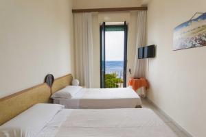 Postel nebo postele na pokoji v ubytování Albergo Palazzo